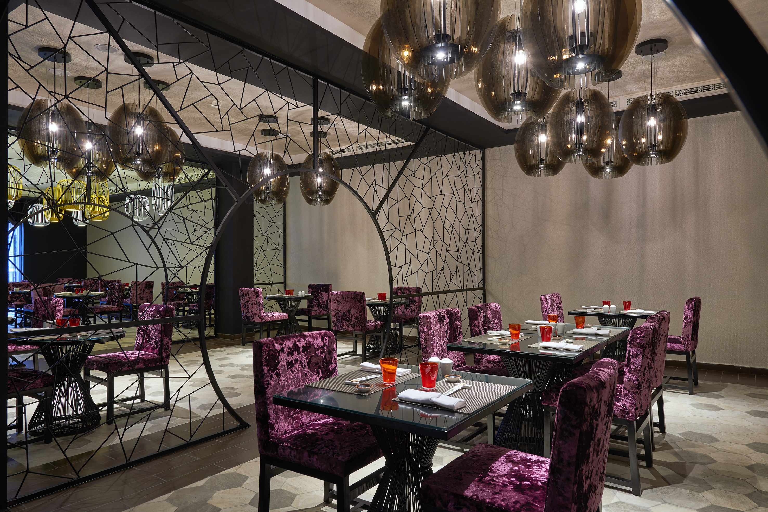 a room with purple chairs and tables