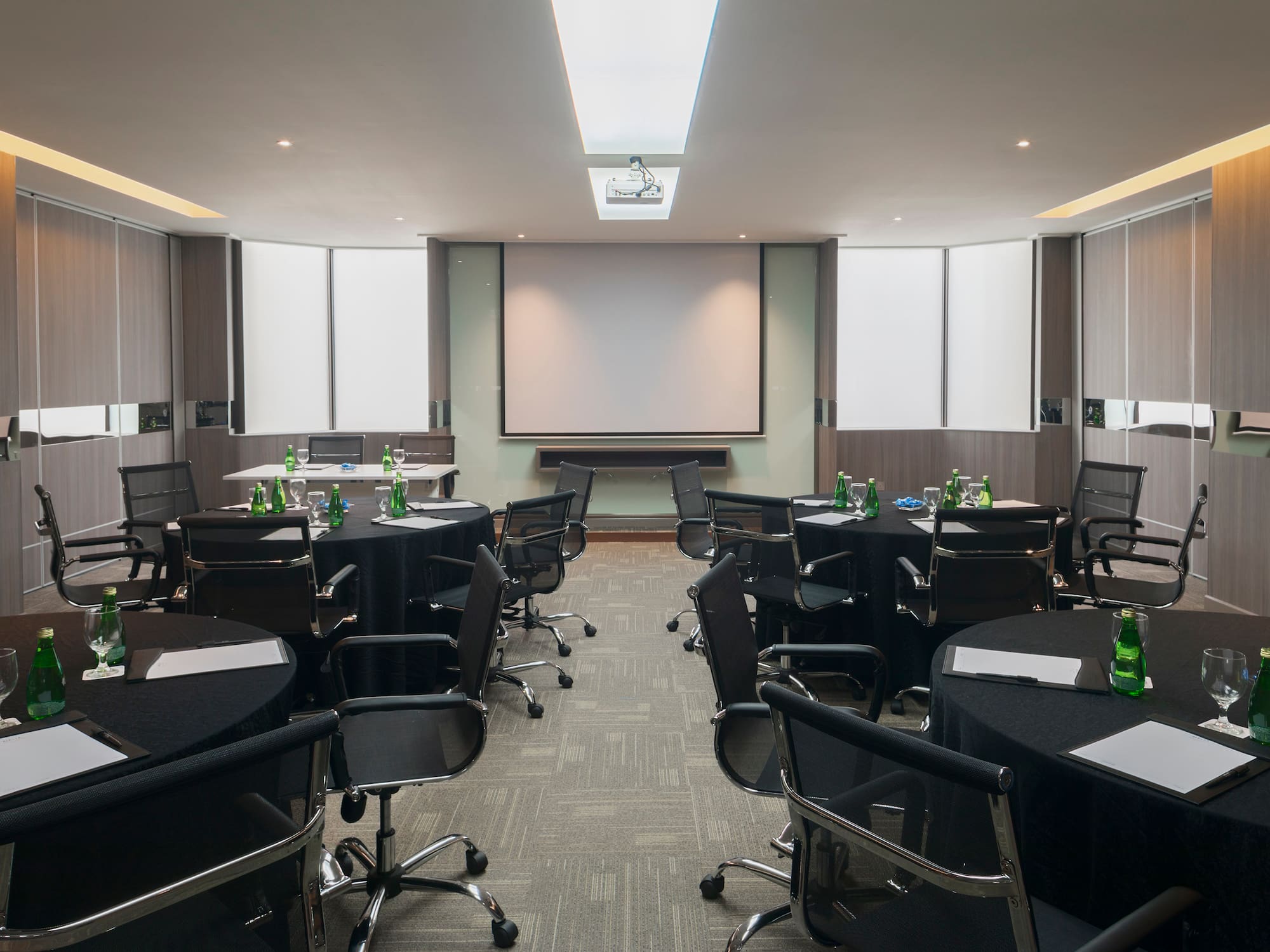 a room with black chairs and tables