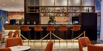 a bar with chairs and a bar with a rope around it