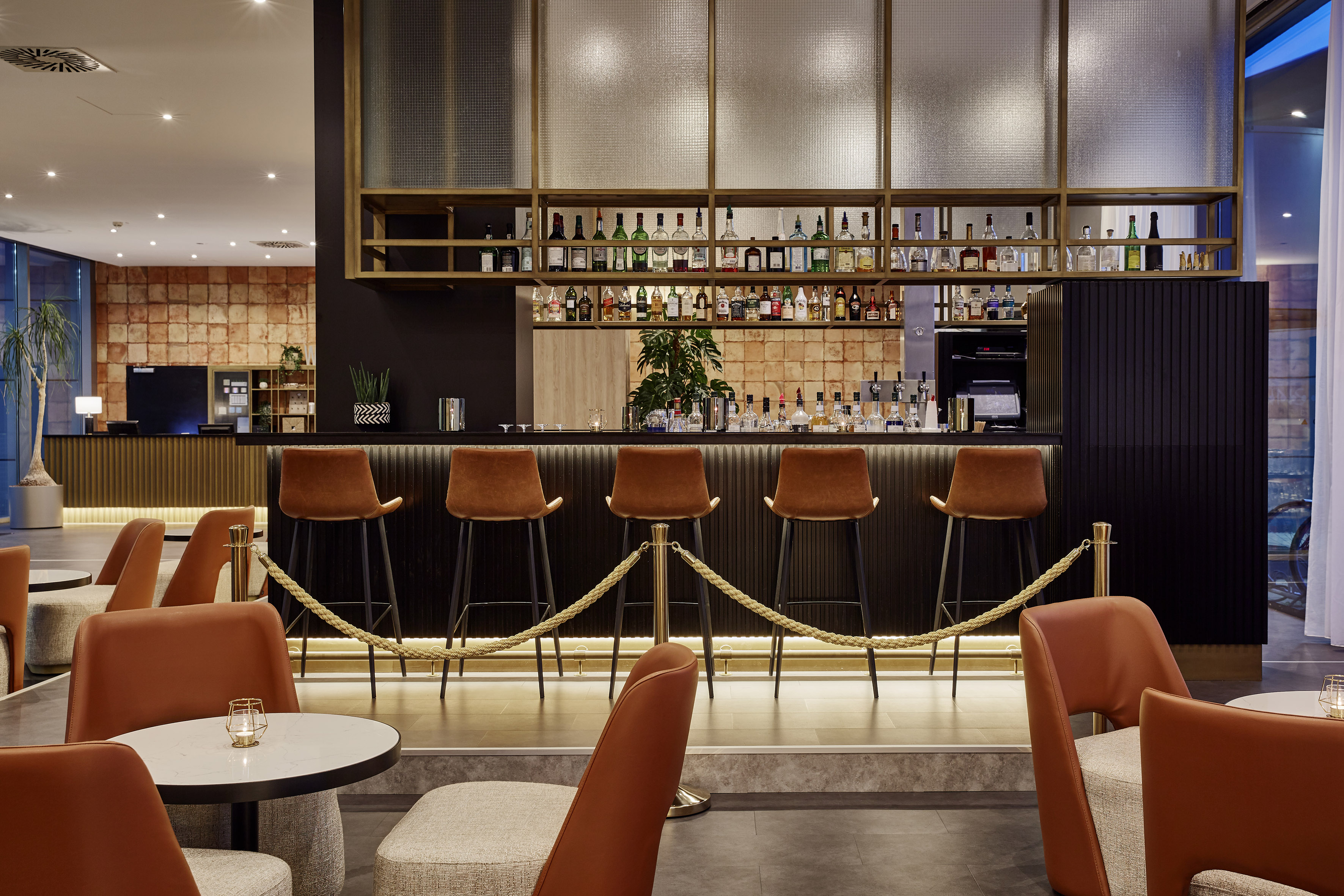 a bar with chairs and a bar with a rope around it