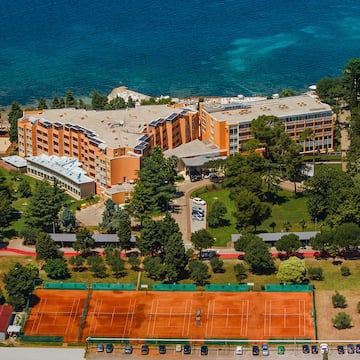 a tennis court and a building by the water