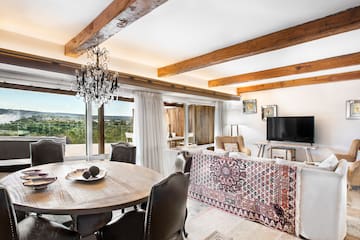 a living room with a table and chairs