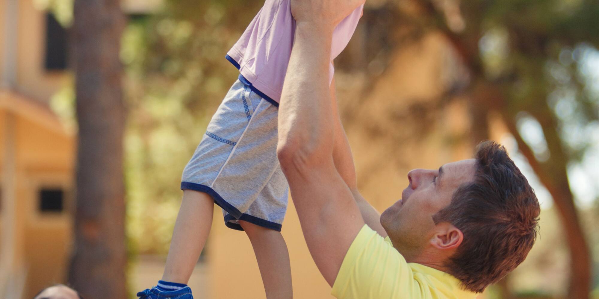 a man and child playing basketball