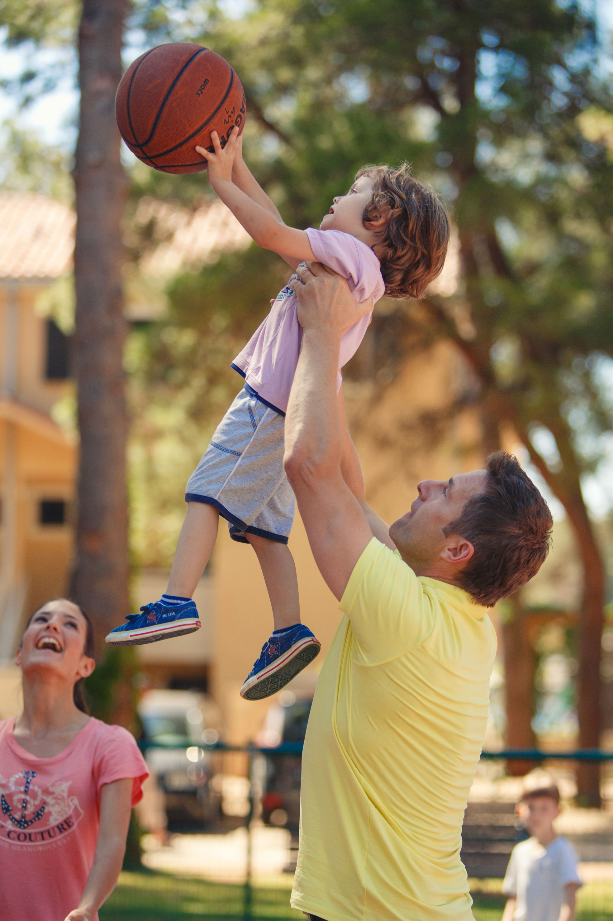 a man and child playing basketball