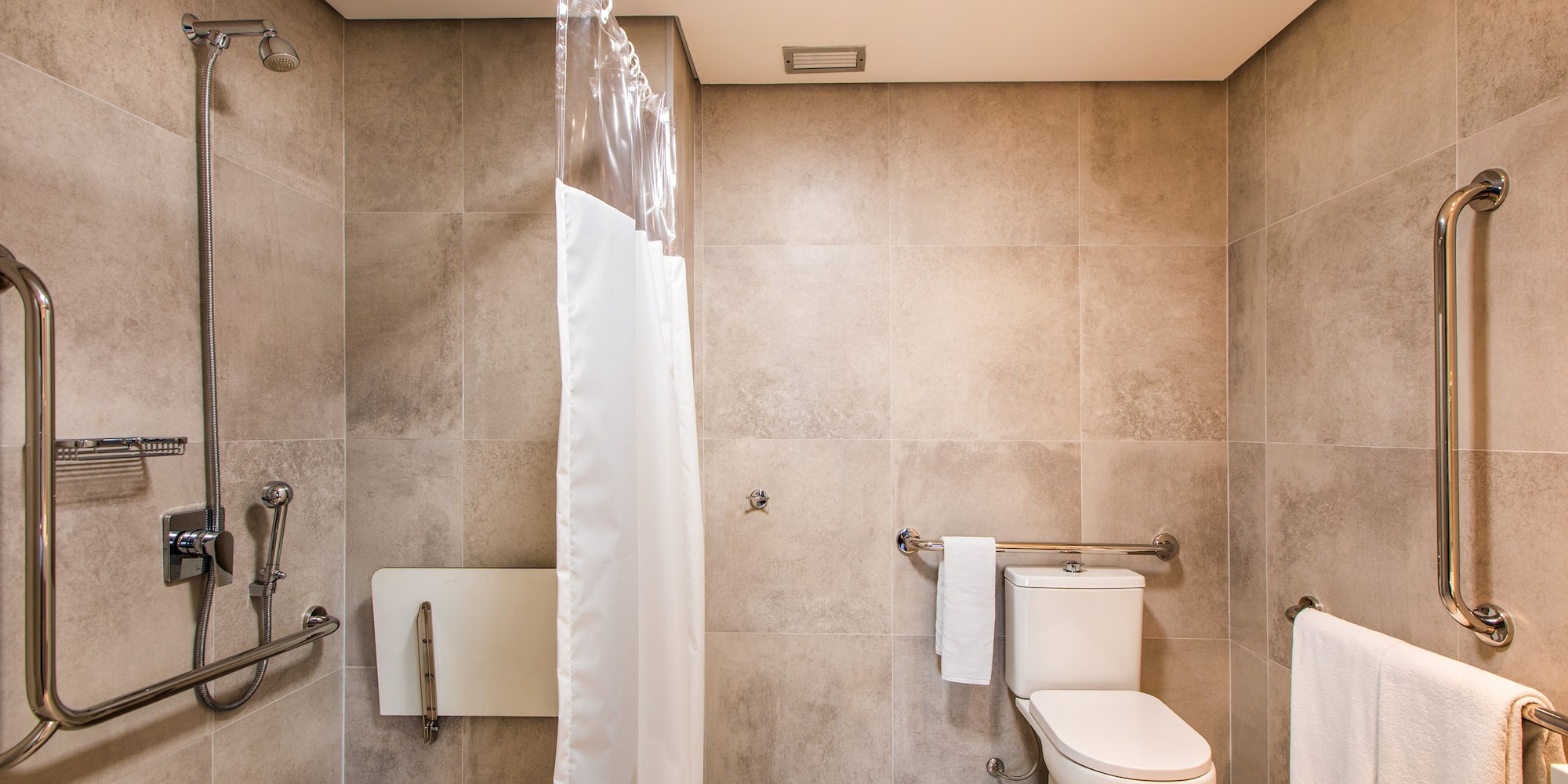 a bathroom with a toilet and shower curtain