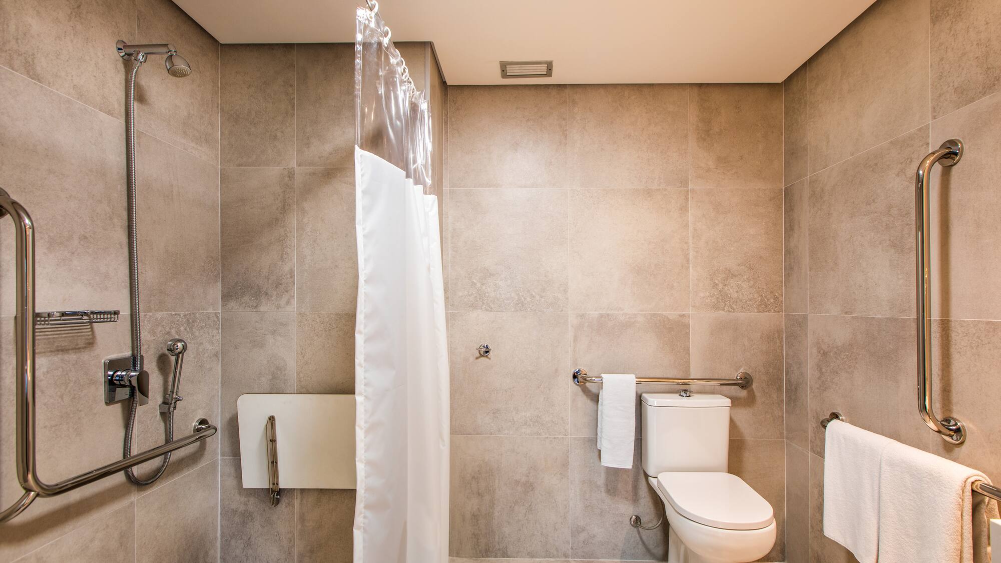 a bathroom with a toilet and shower curtain