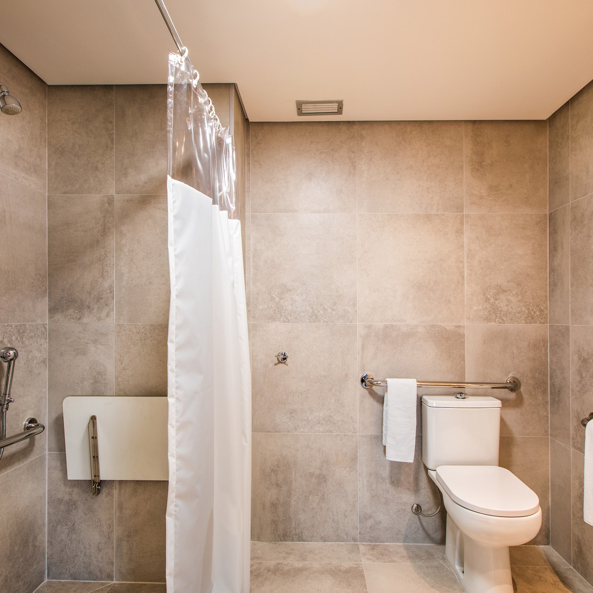 a bathroom with a toilet and shower curtain
