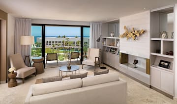 a living room with a large glass door and a view of the ocean