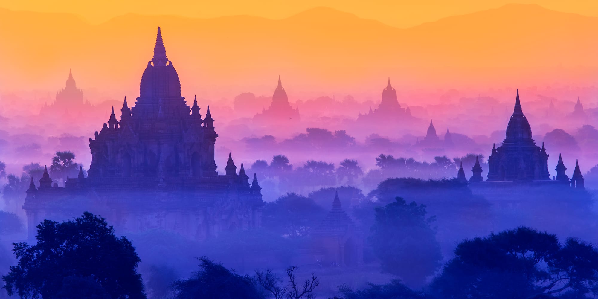 a landscape with a large building and trees