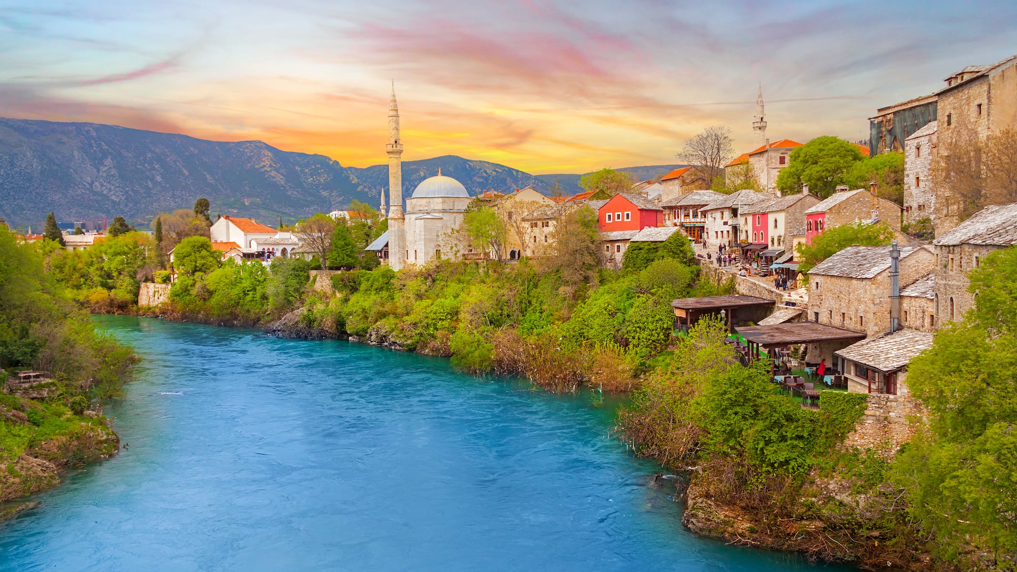 a river with buildings and trees