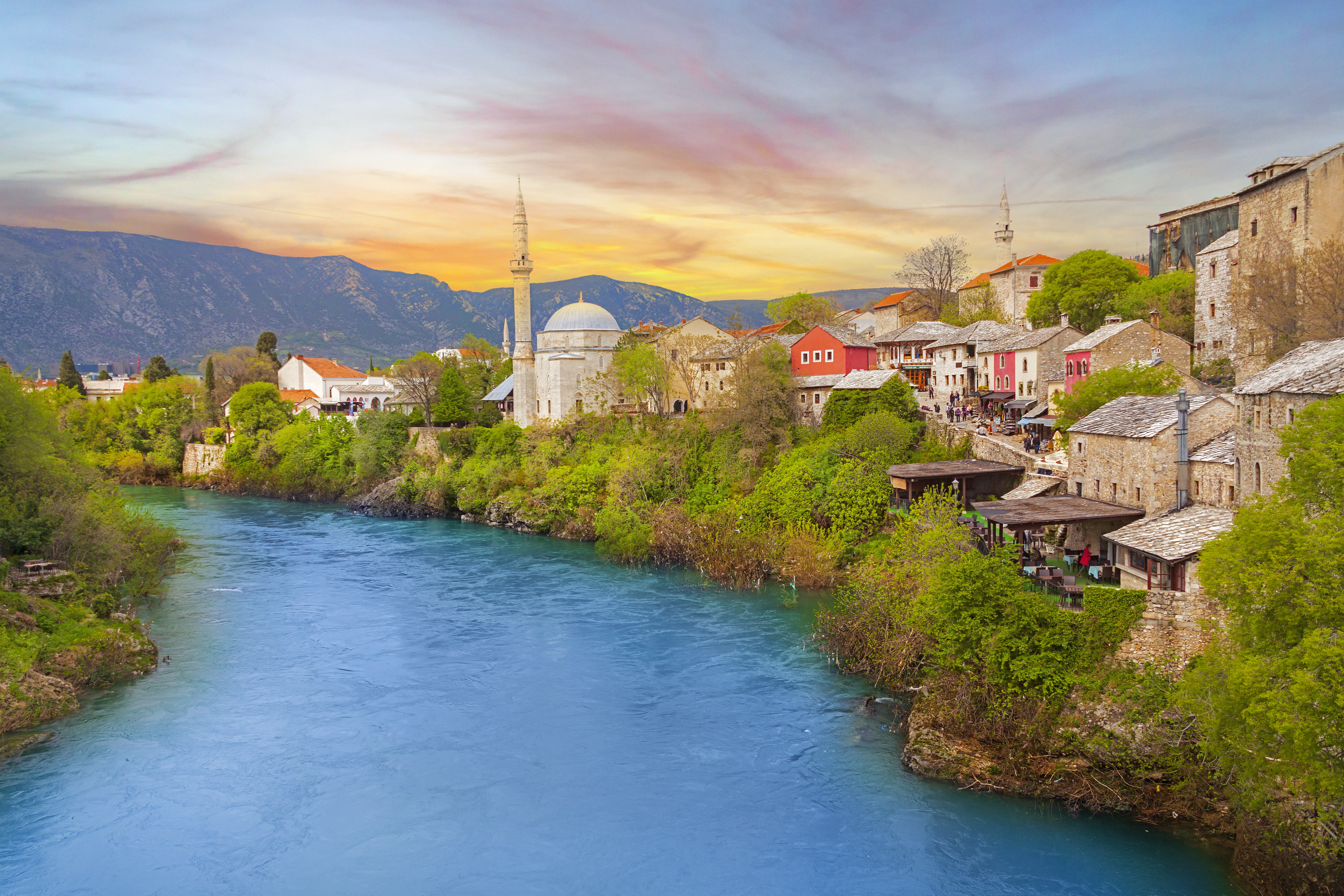 a river with buildings and trees