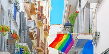 a rainbow flag from a balcony