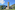 a stone building with a tower in front of a mountain
