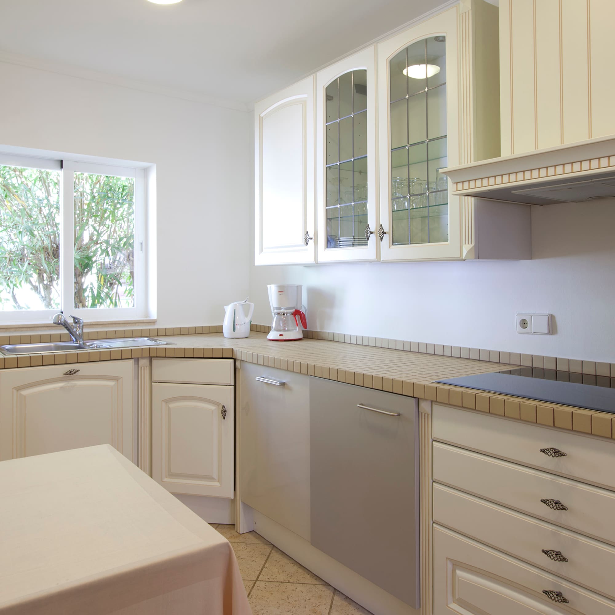 a kitchen with white cabinets and white counter tops