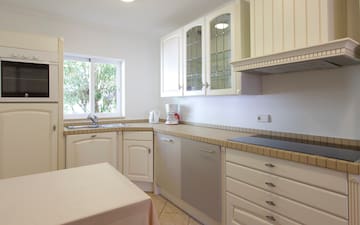 a kitchen with white cabinets and white counter tops