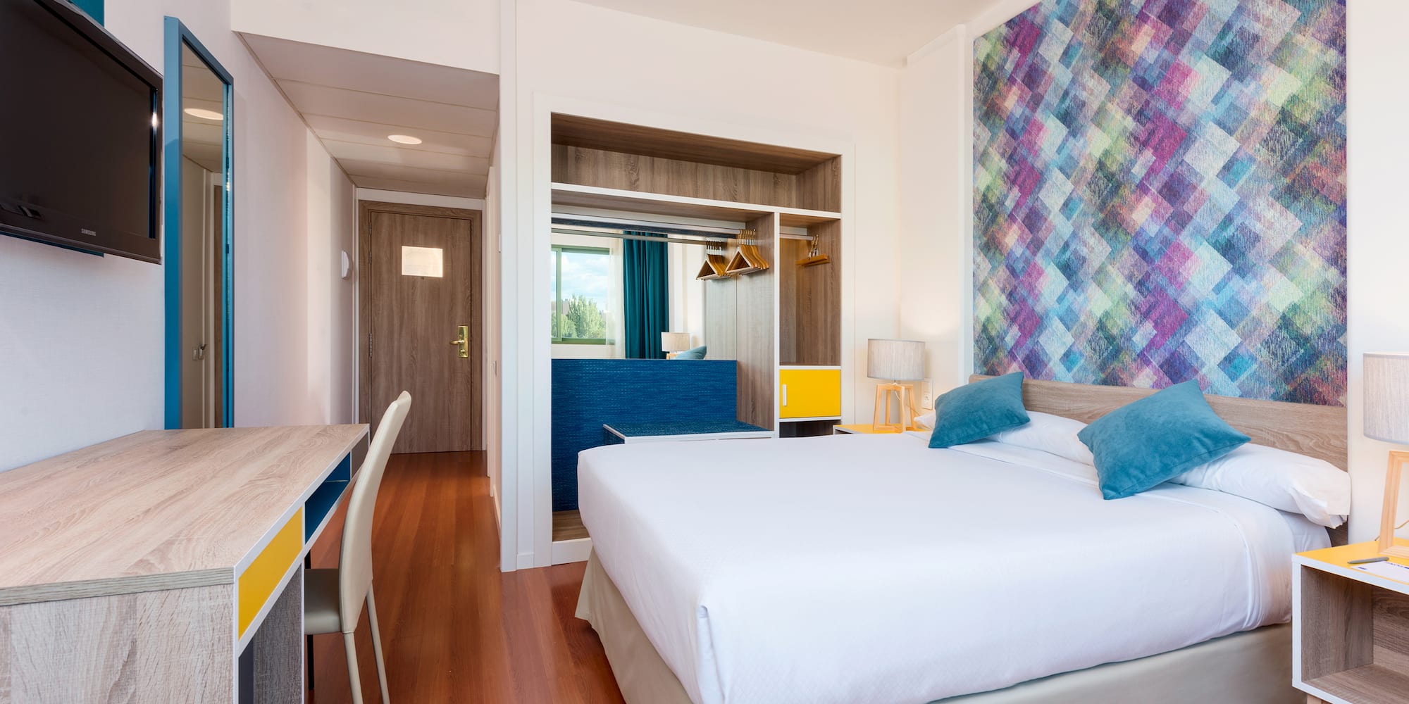 a room with a bed and a desk