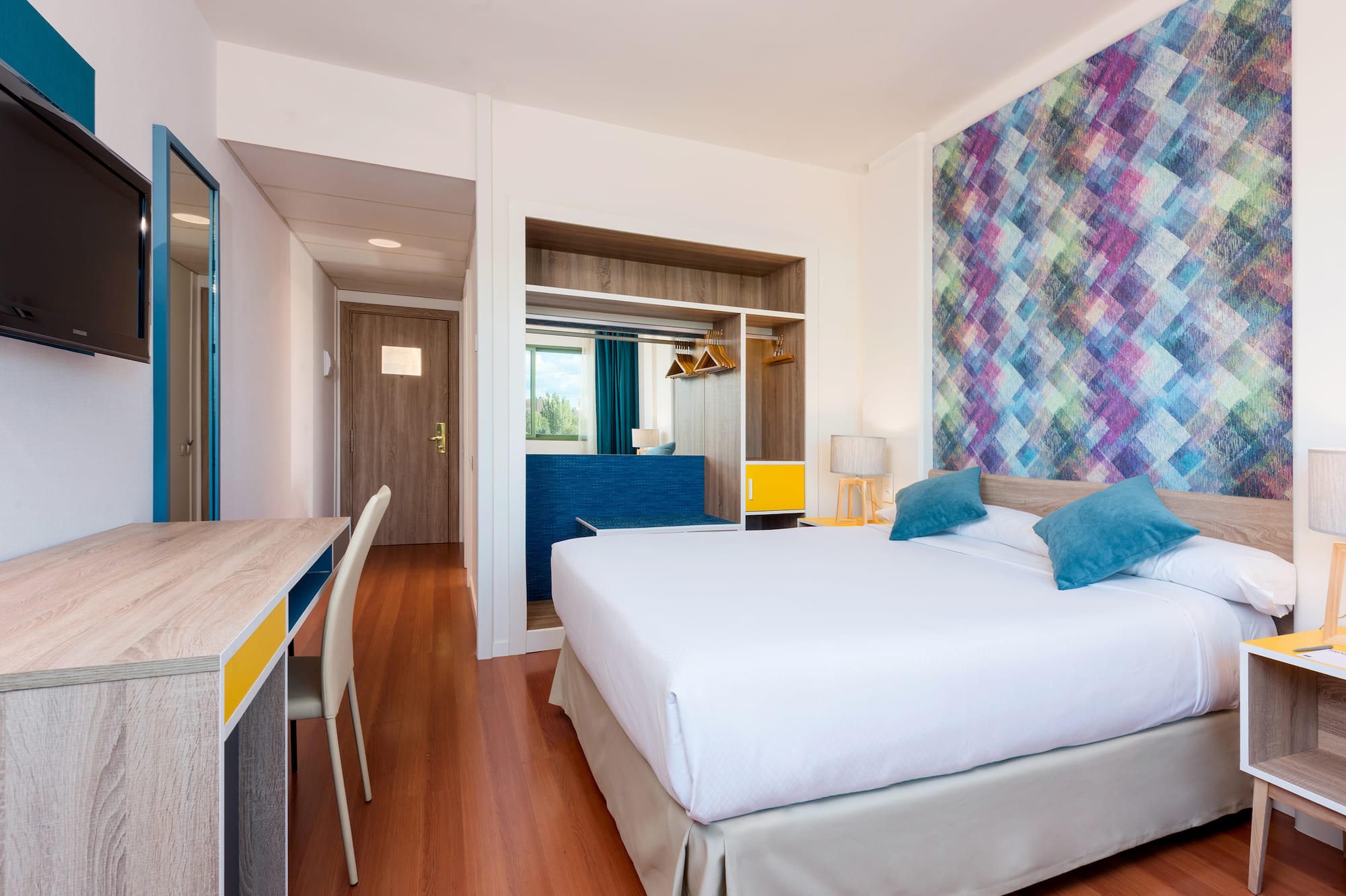 a room with a bed and a desk