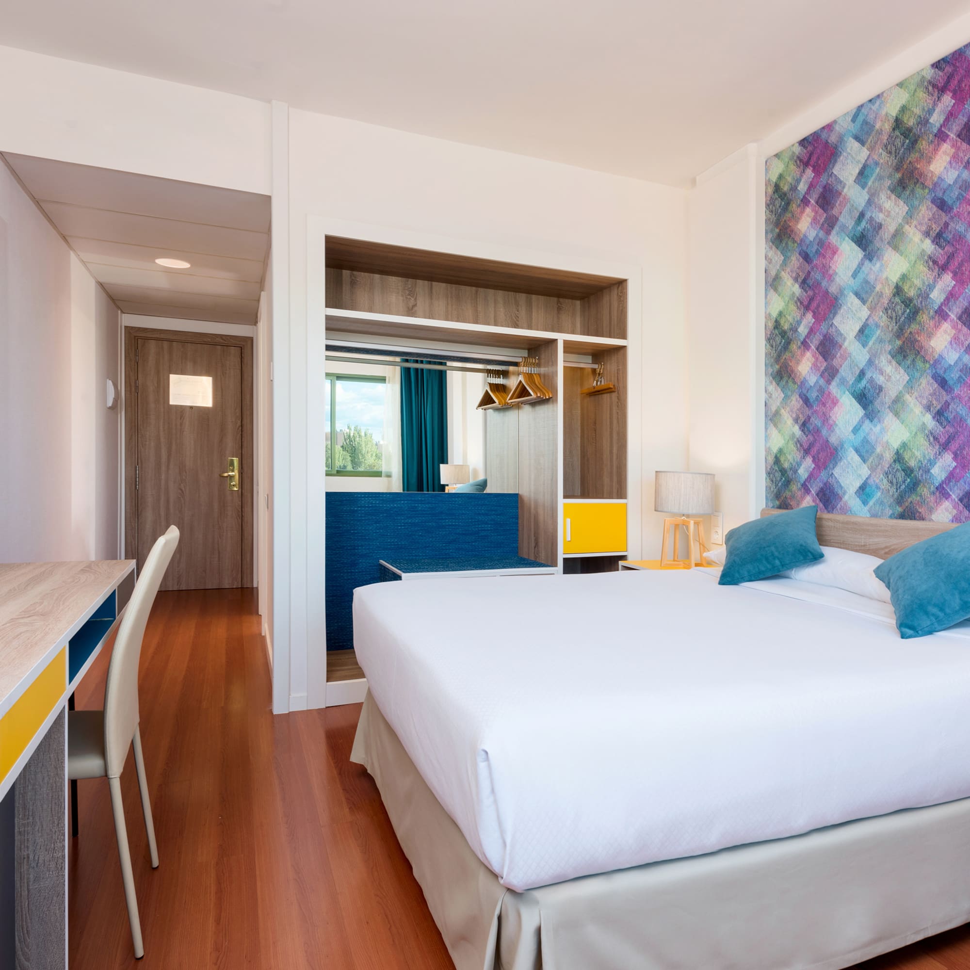 a room with a bed and a desk