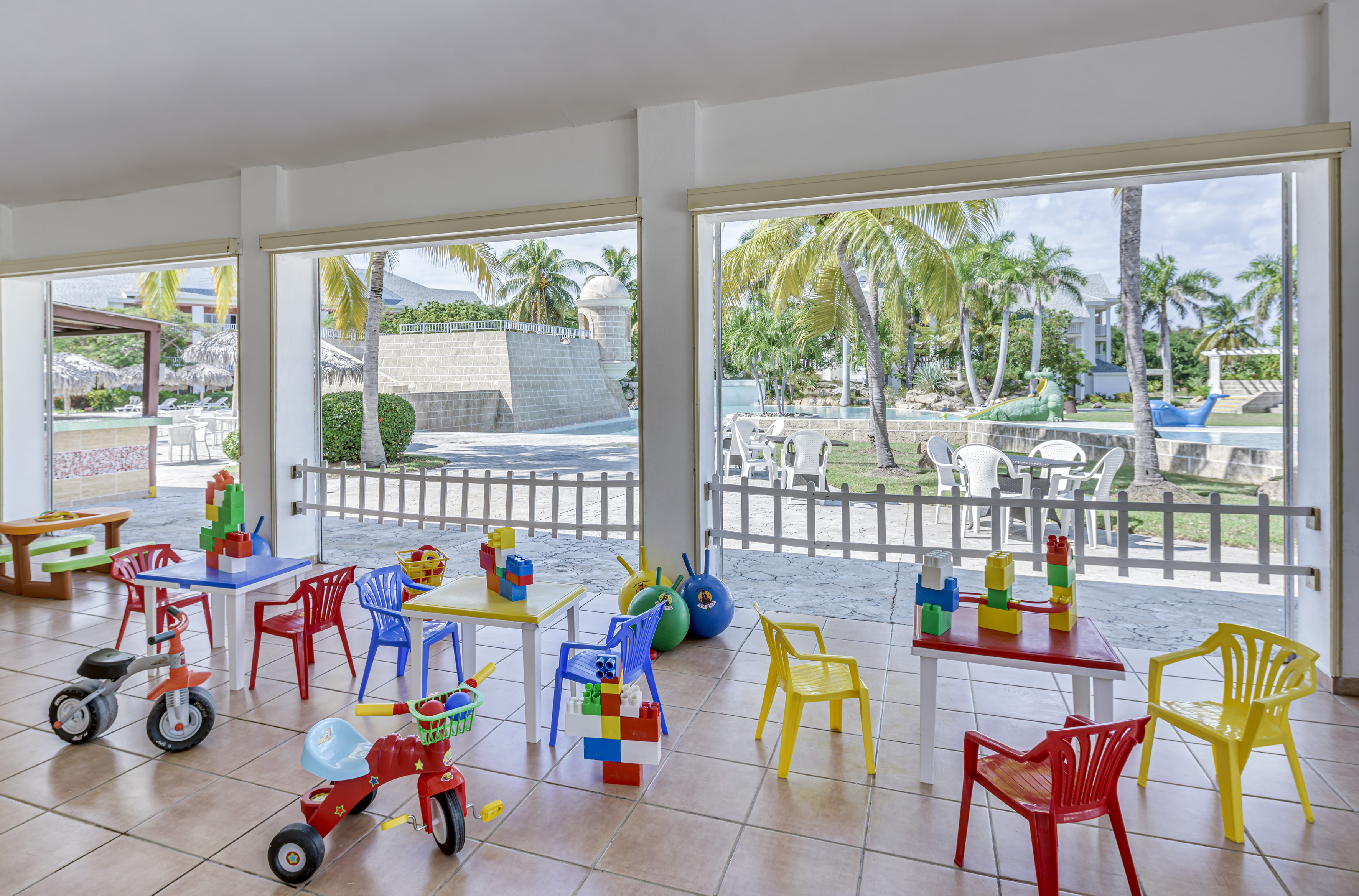 a room with a table and chairs and toys