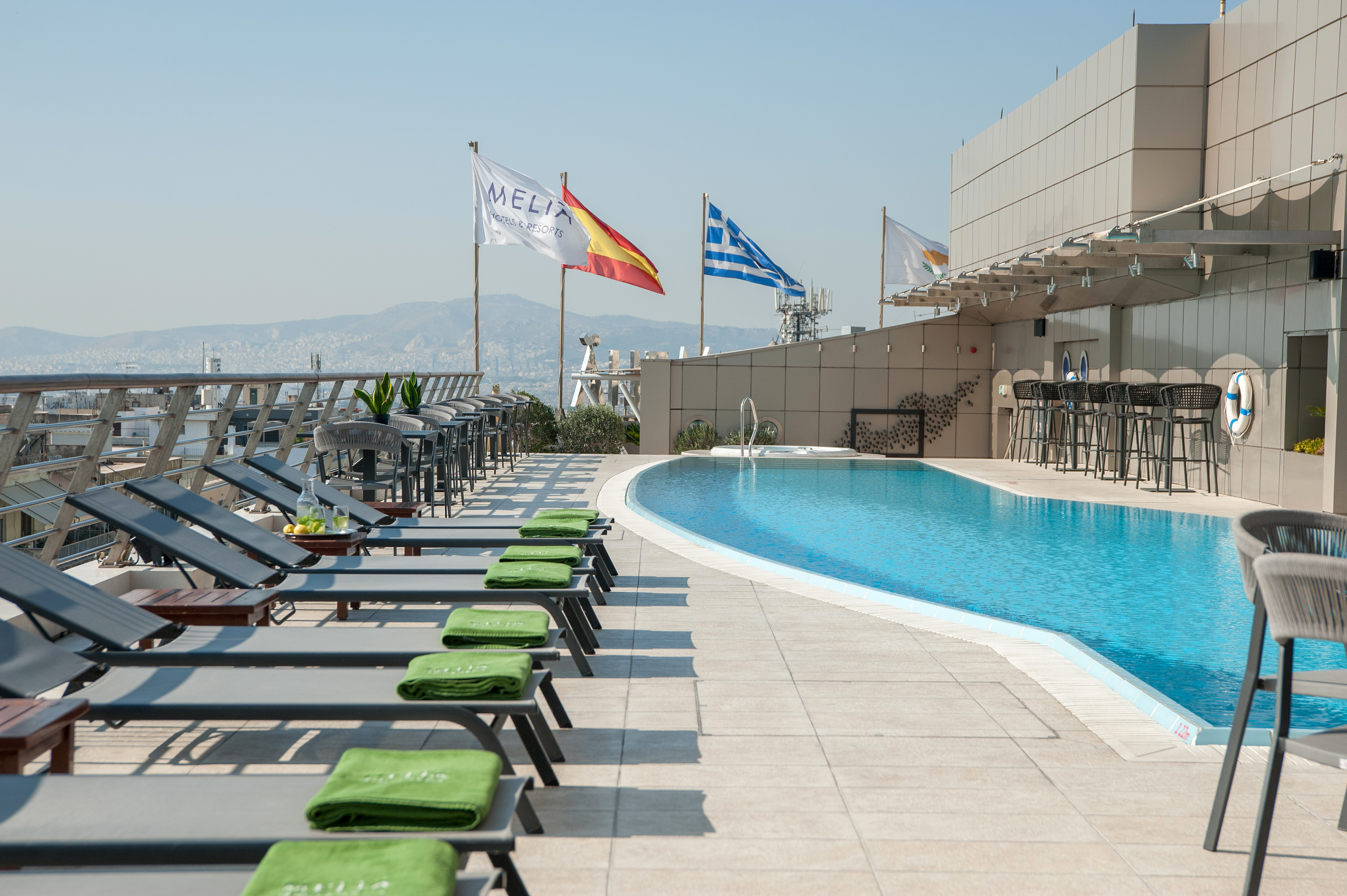a pool with chairs and flags