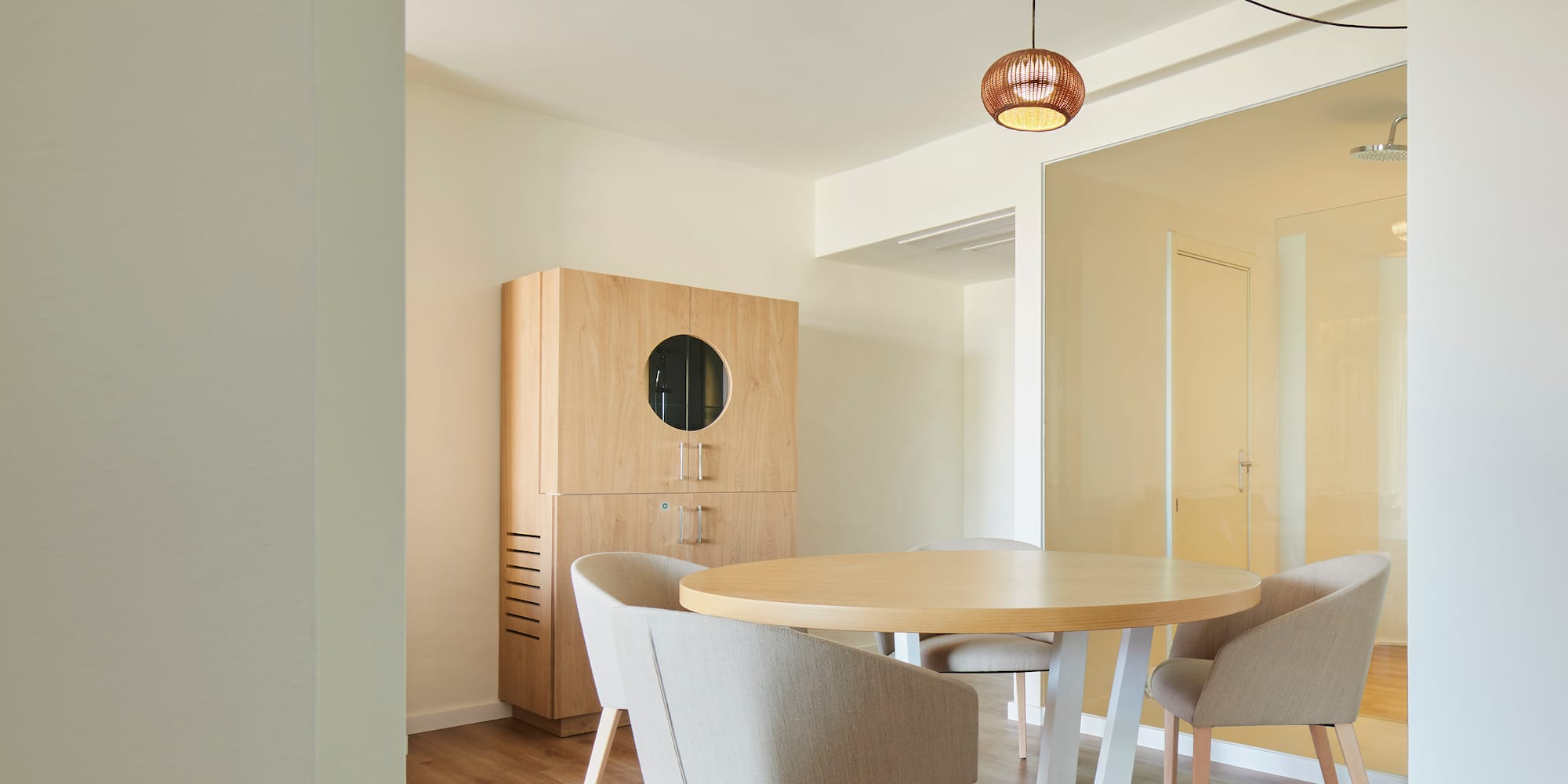 a room with a round table and chairs