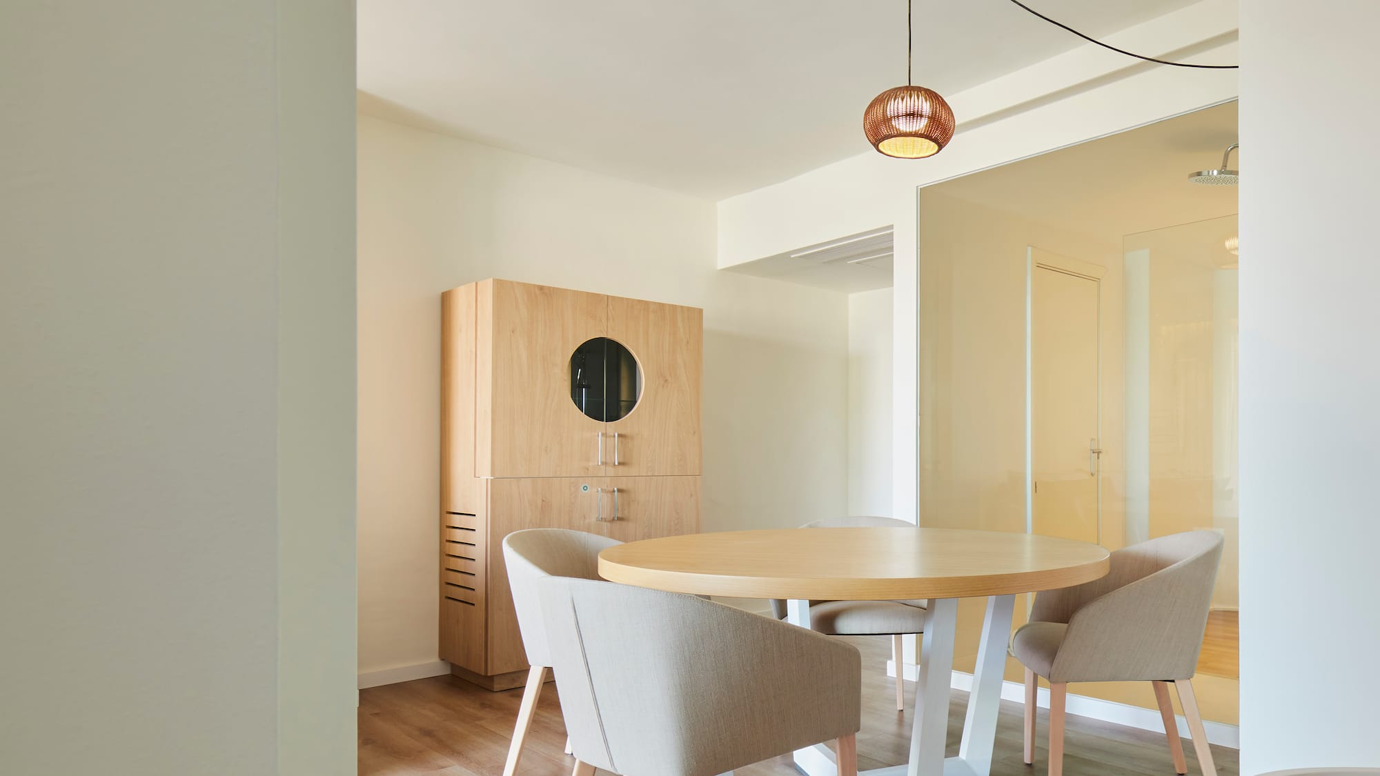 a room with a round table and chairs