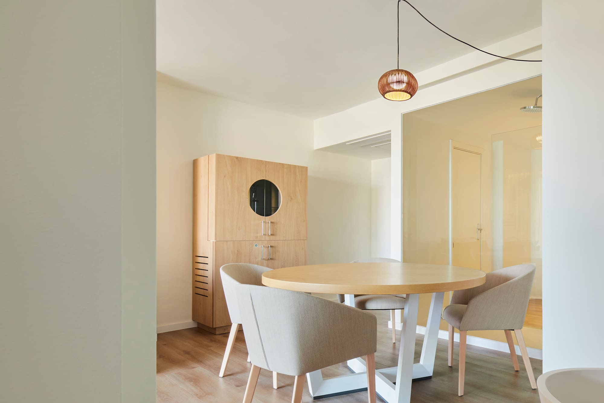 a room with a round table and chairs