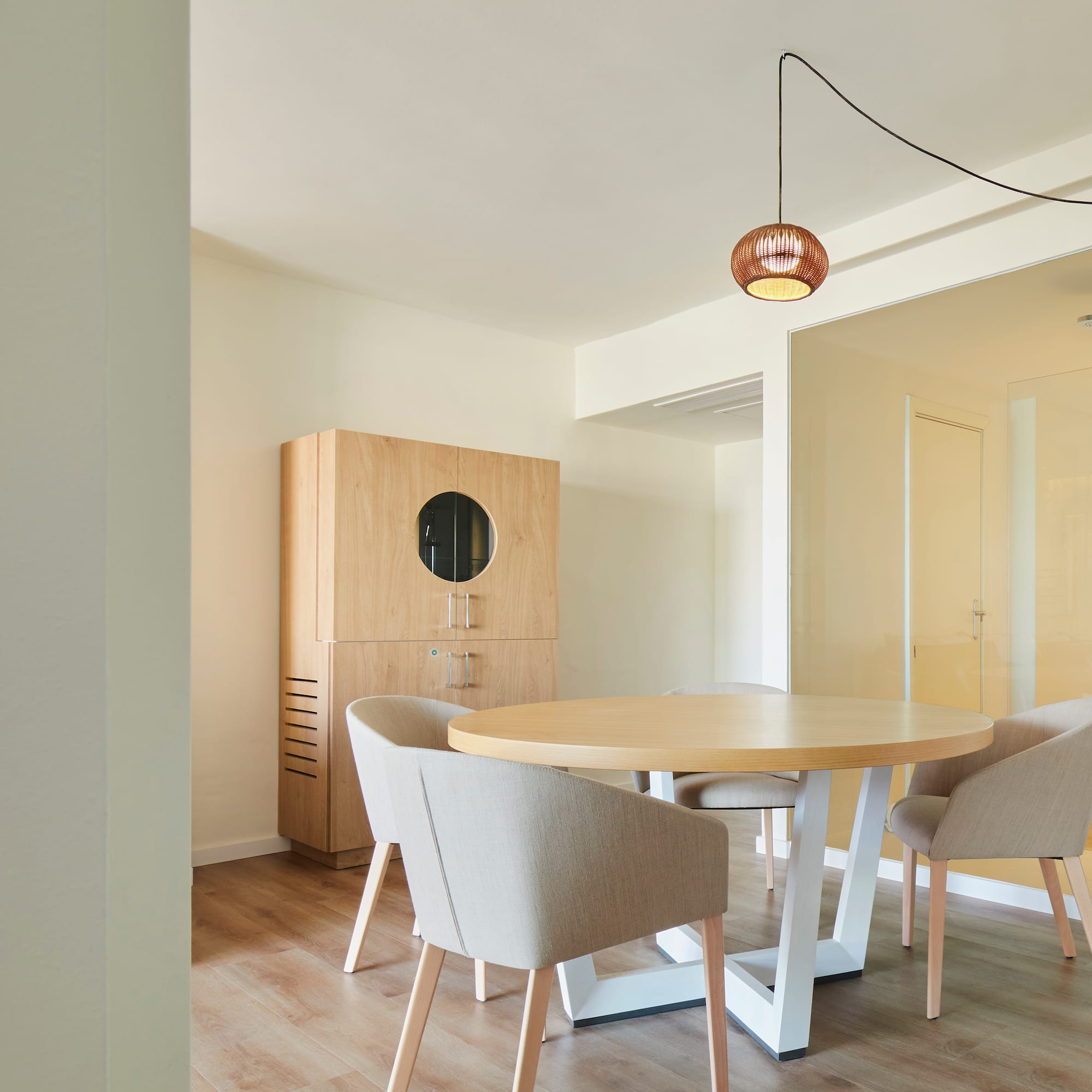 a room with a round table and chairs