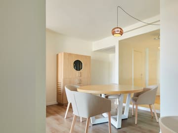 a room with a round table and chairs