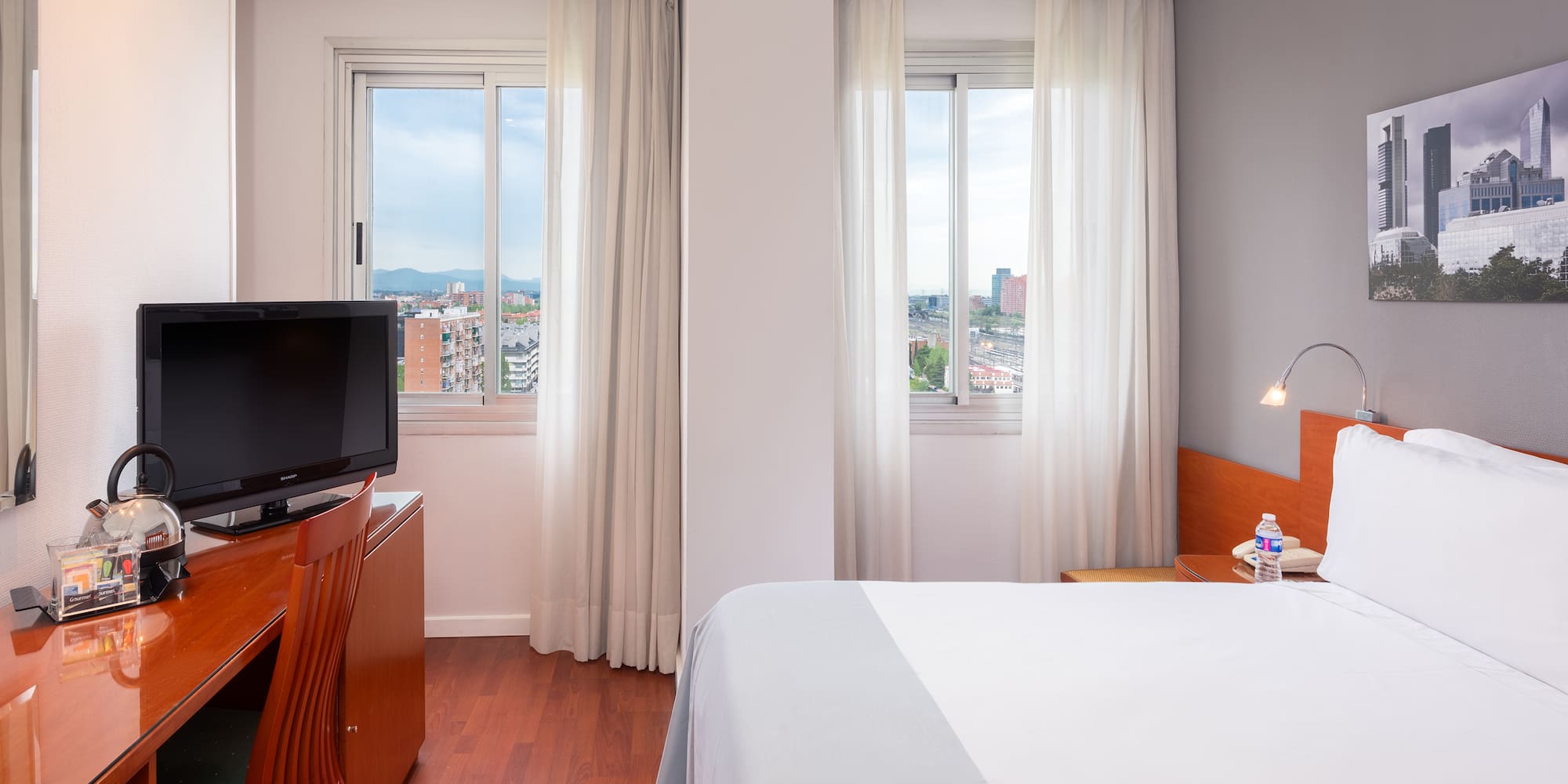 a bedroom with a television and a window