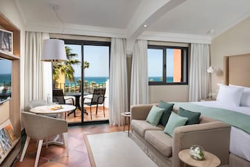 a room with a bed and a table and chairs