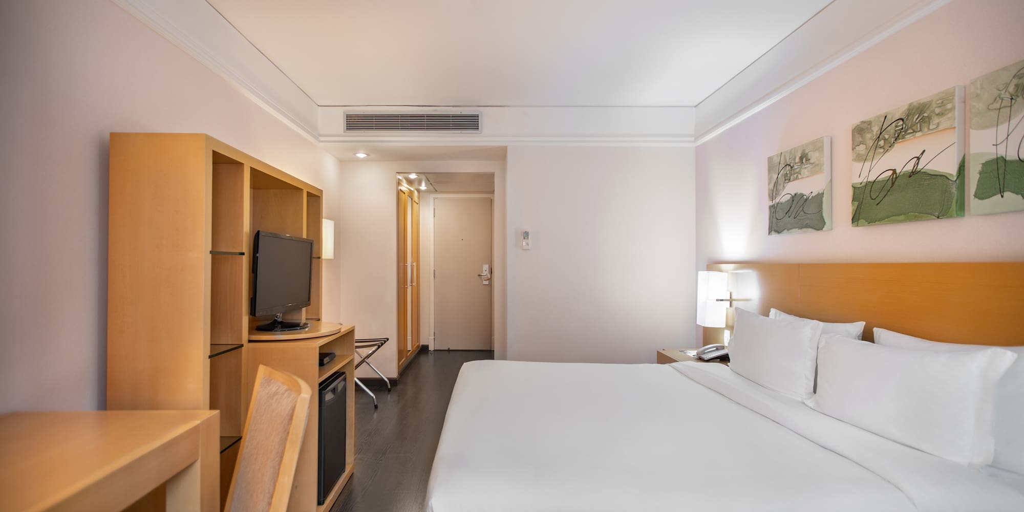 a room with a bed and a television