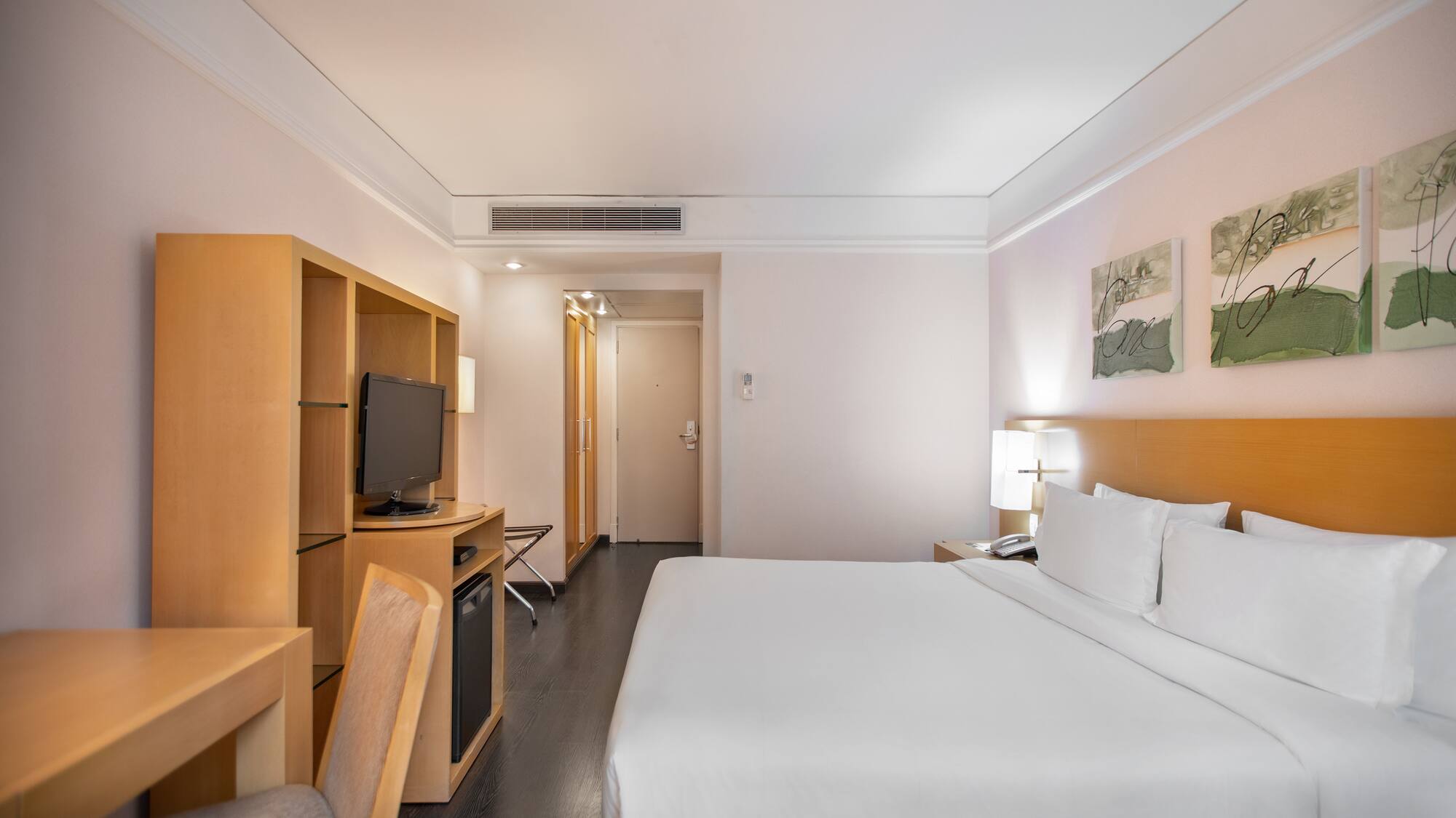 a room with a bed and a television