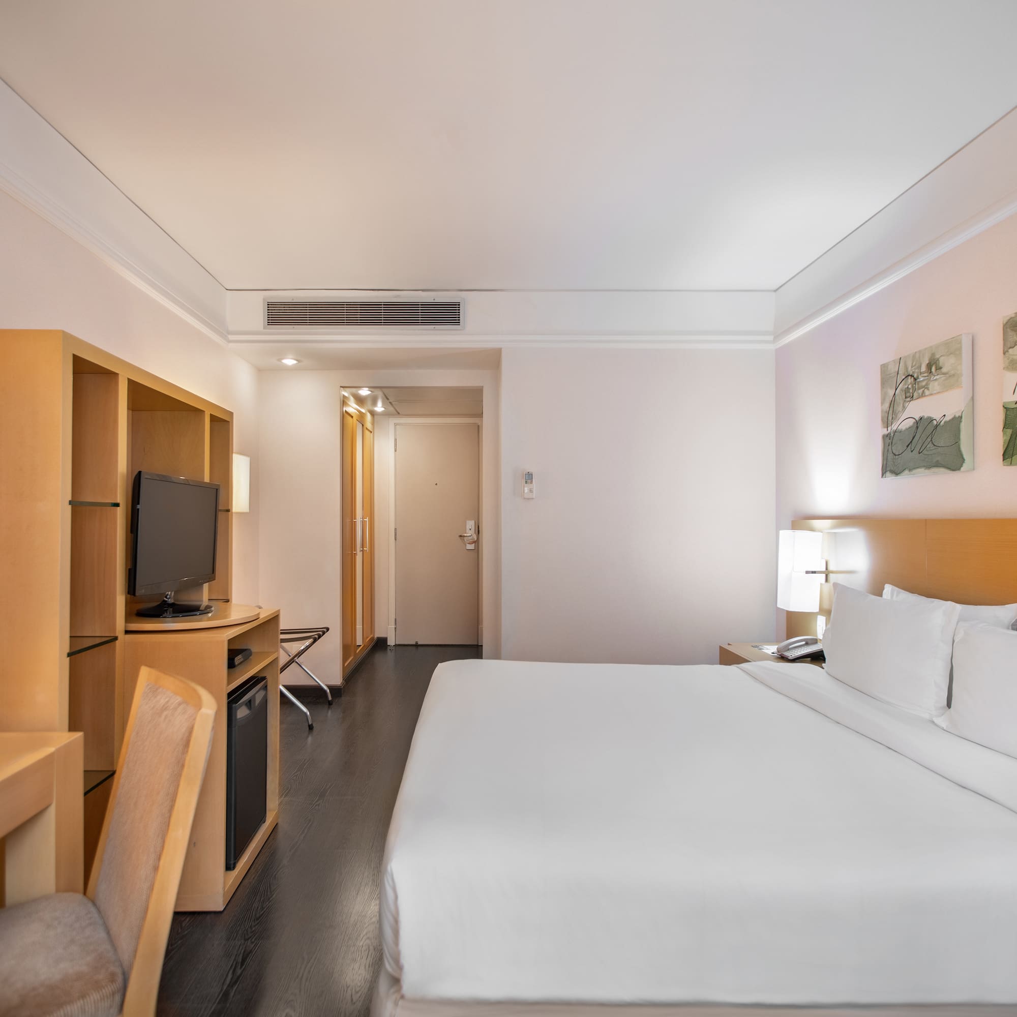 a room with a bed and a television