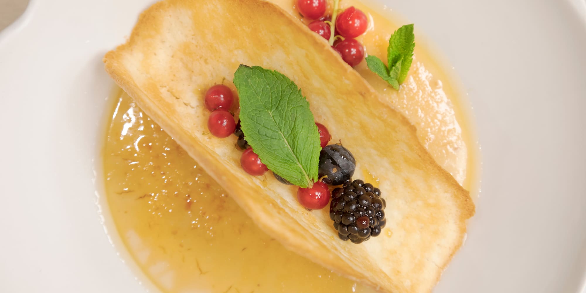 a plate of food with berries and leaves