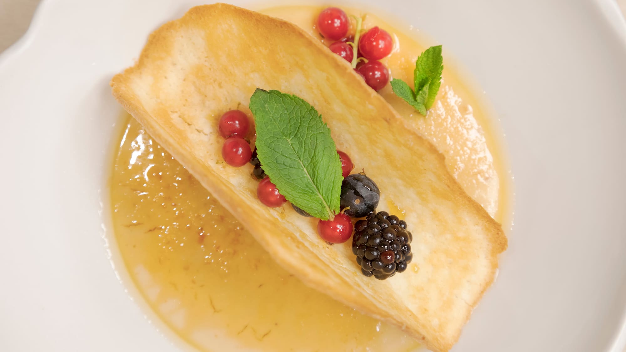 a plate of food with berries and leaves