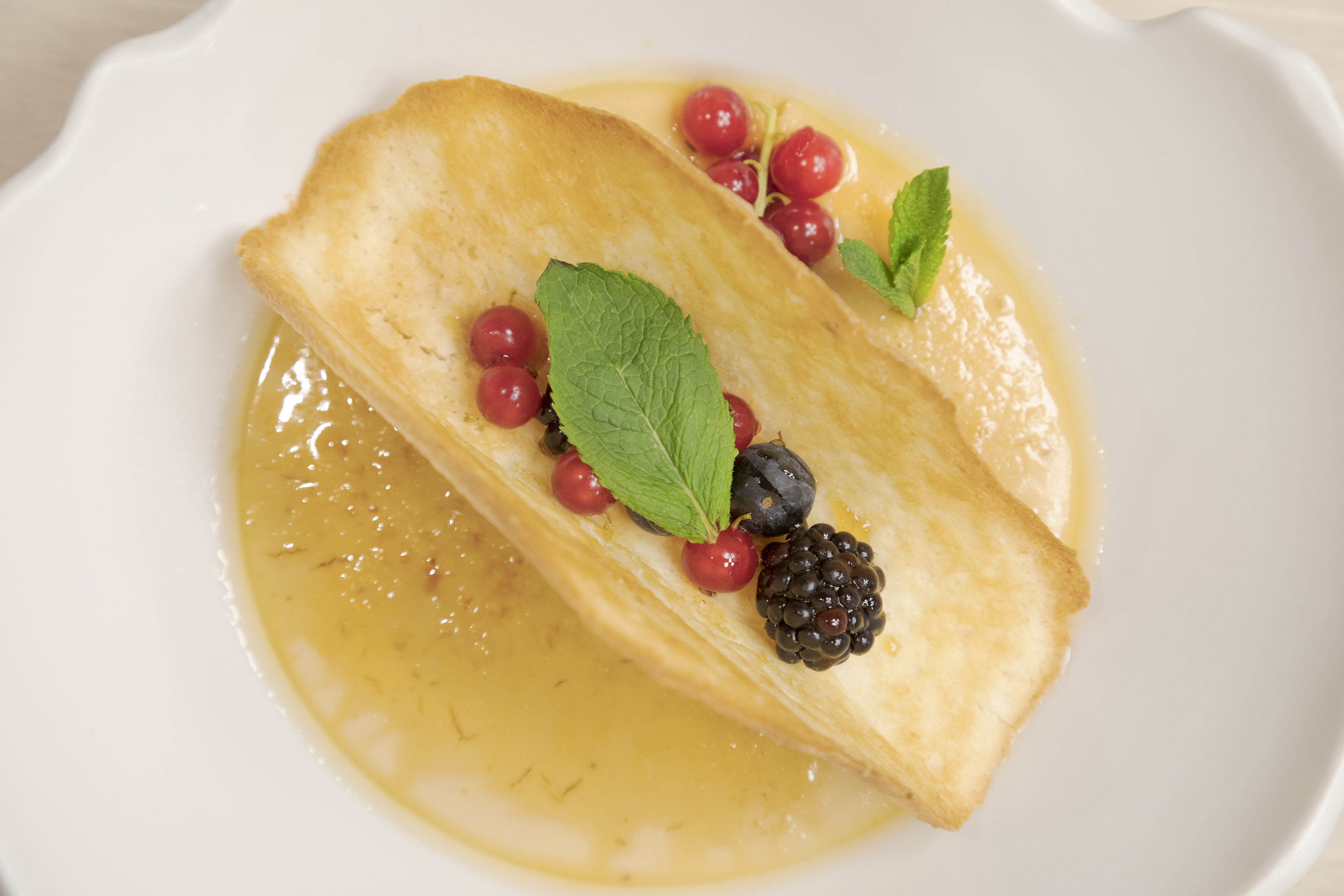 a plate of food with berries and leaves