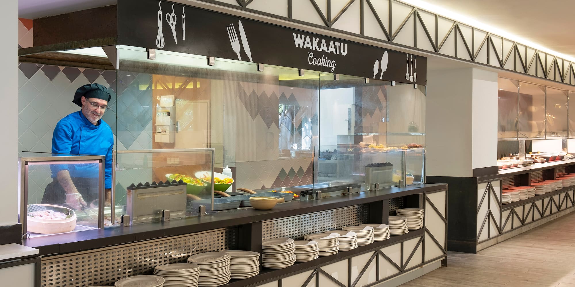 a chef standing behind a counter