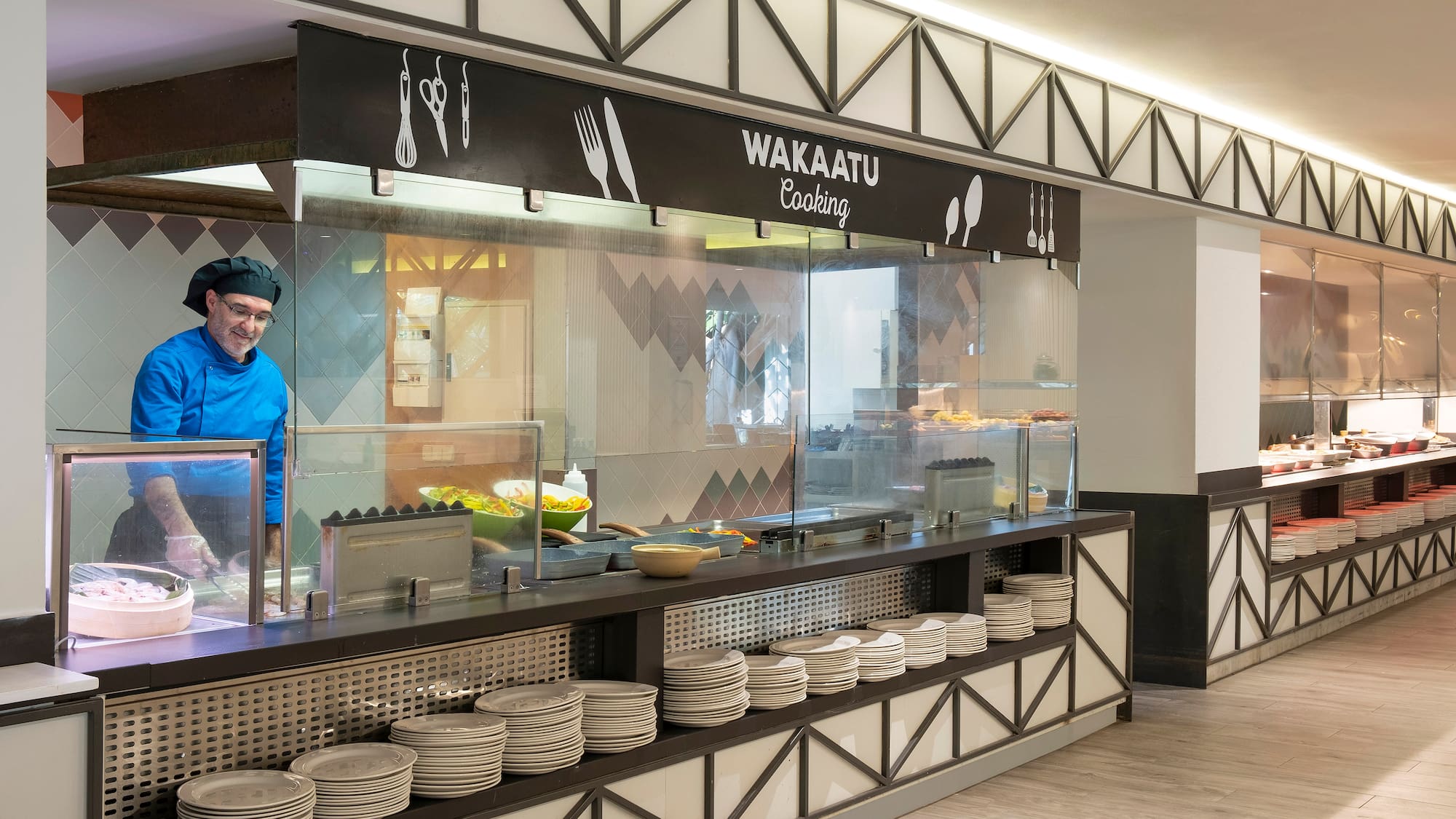 a chef standing behind a counter
