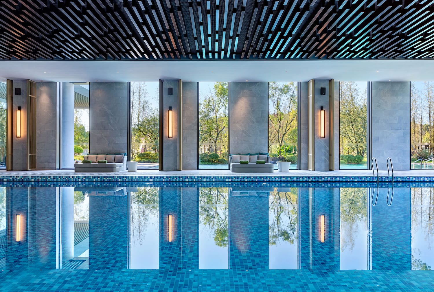 a pool with a large room with a large window