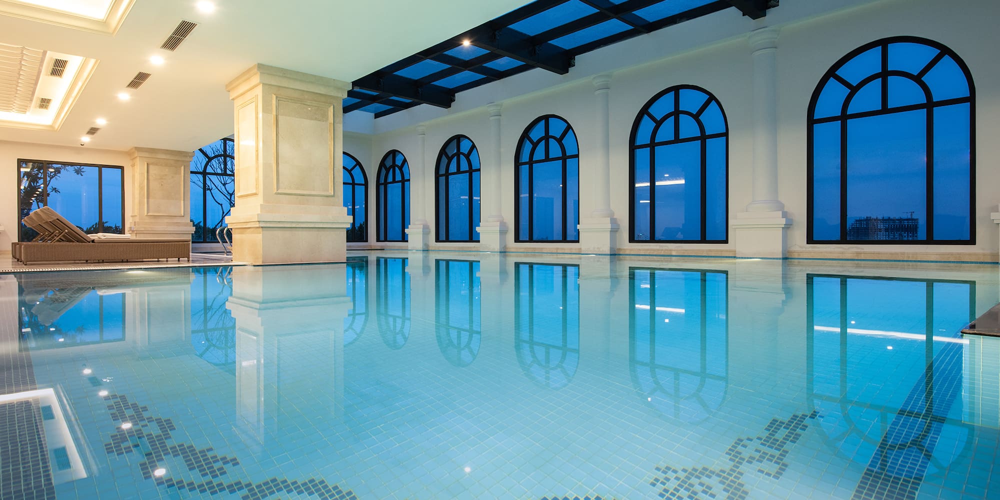 a indoor pool with arched windows