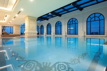a indoor pool with arched windows