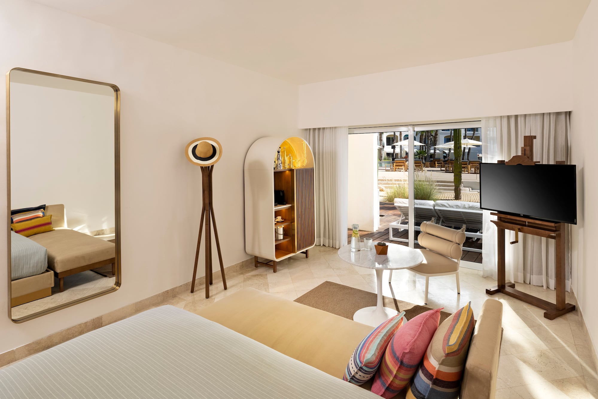 a room with a bed and a television