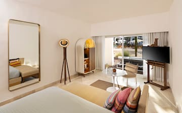 a room with a bed and a television
