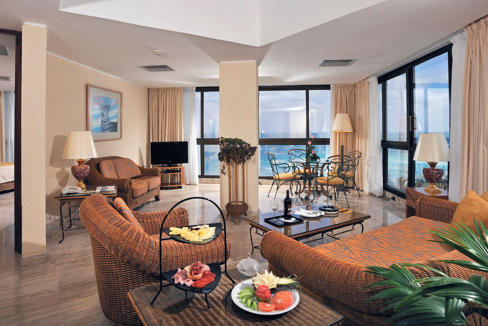 a living room with a large window overlooking the ocean