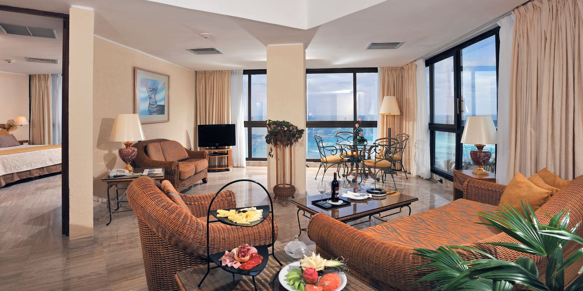 a living room with a large window overlooking the ocean