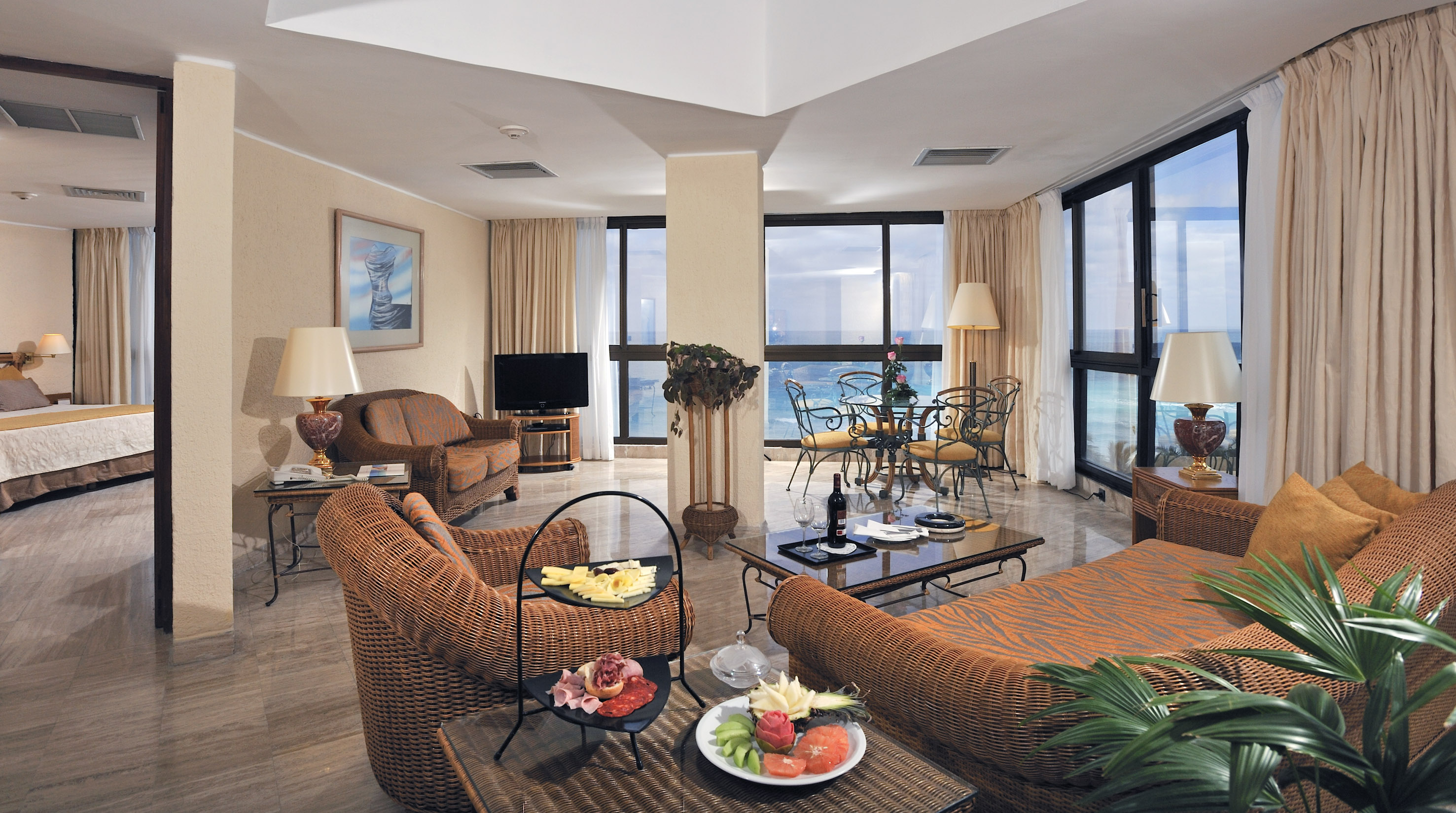 a living room with a large window overlooking the ocean