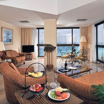 a living room with a large window overlooking the ocean