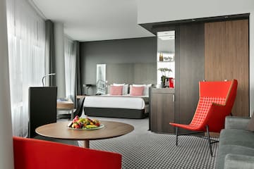 a room with a bed and a table with chairs