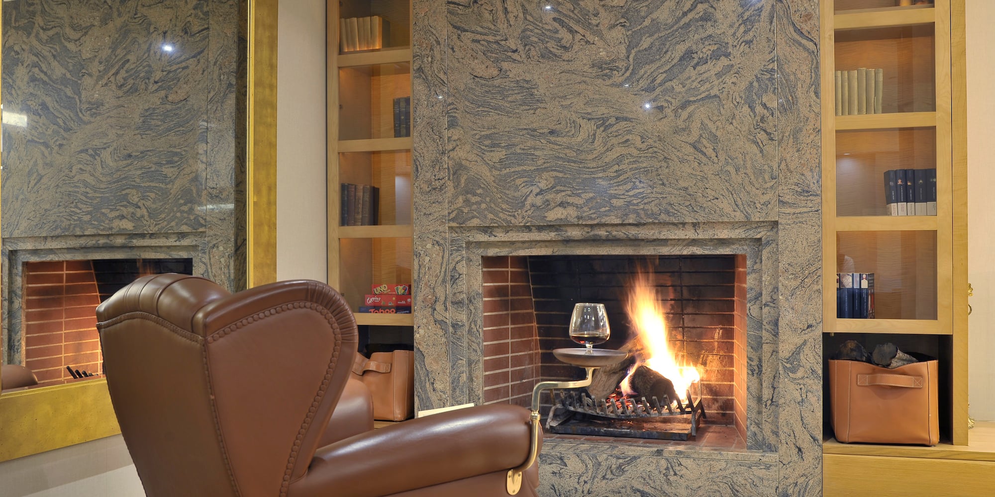 a fireplace with a glass of wine in it